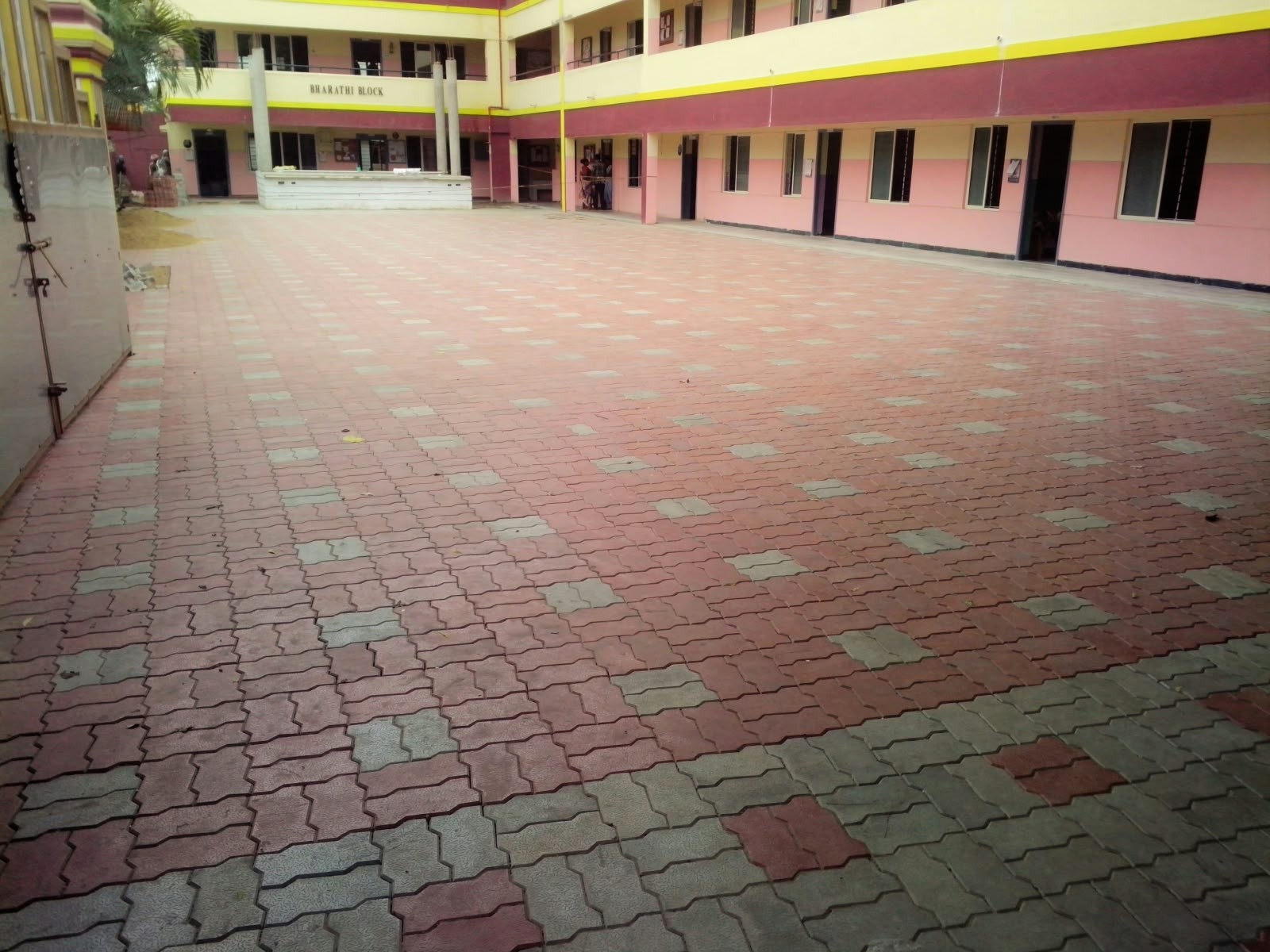 Interlocking wave paver blocks installed across institutional courtyard in Chennai